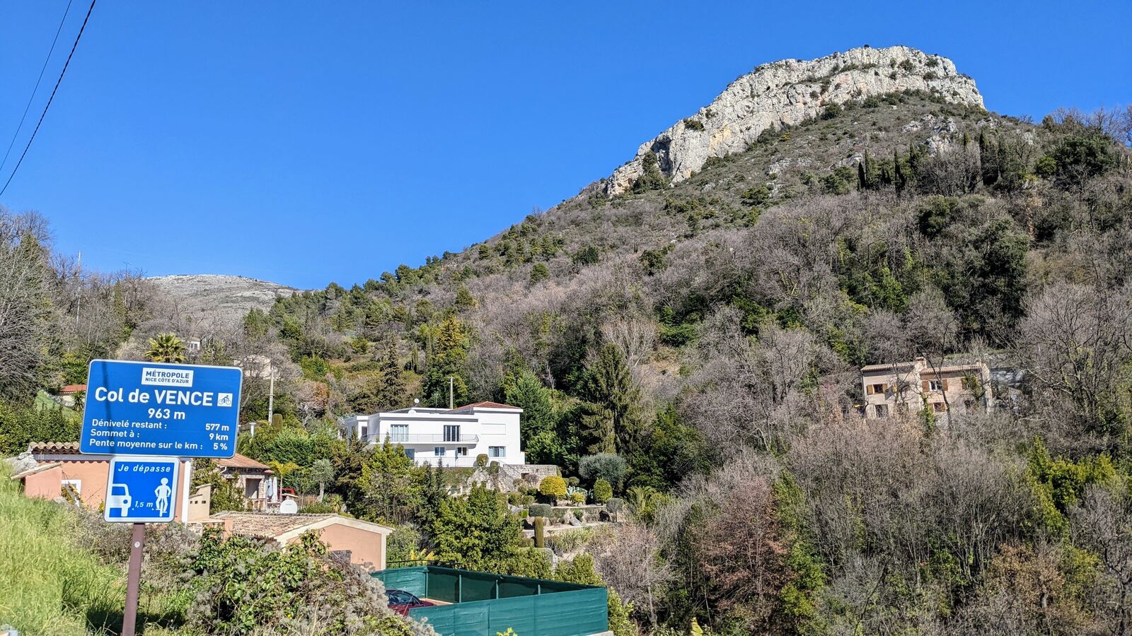 A French hillside with houses below the rocky peak of Col de Vence